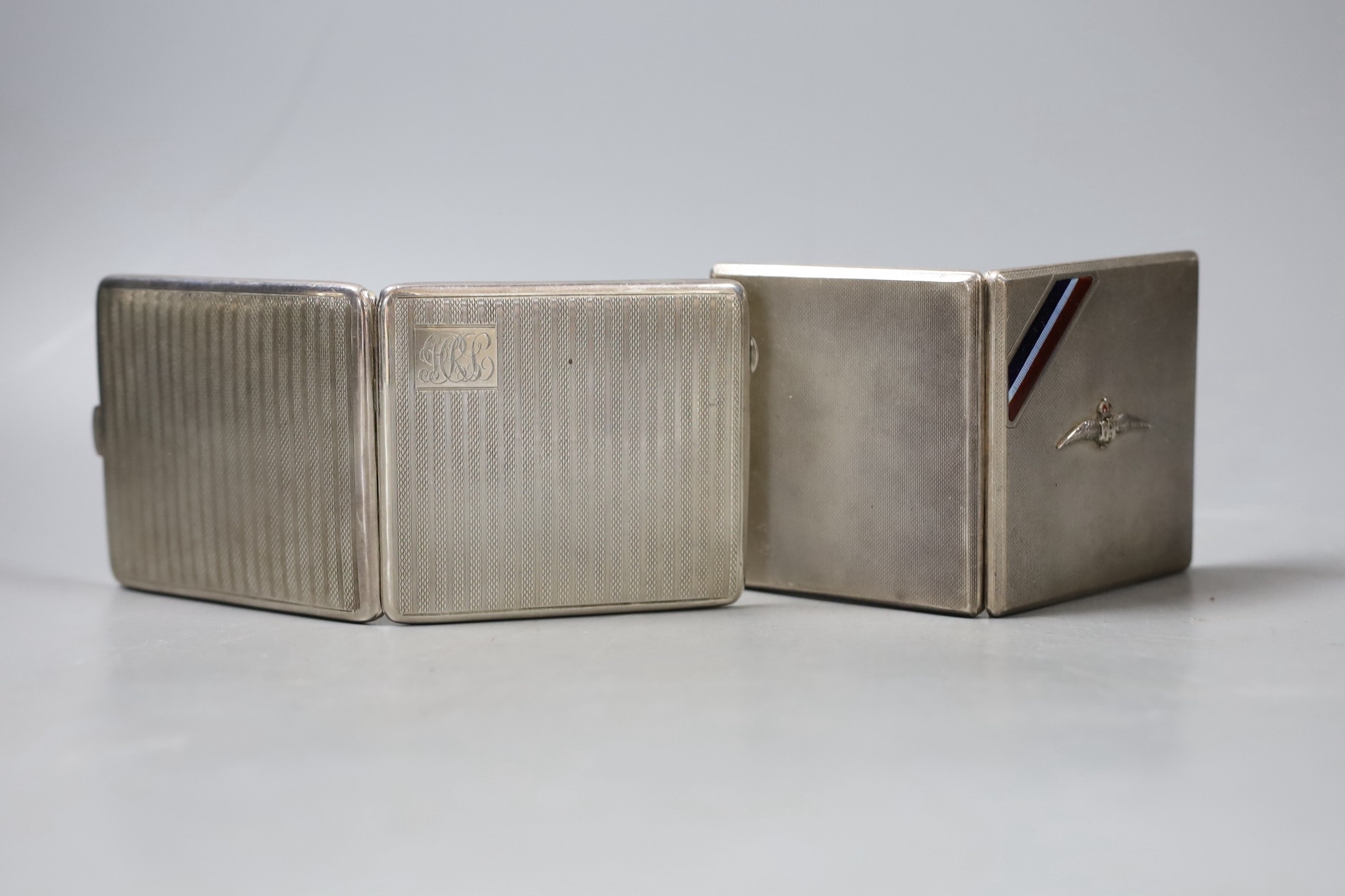 An engine turned RAF enamelled silver cigarette case, 82mm and one other silver cigarette case, gross 239 grams.